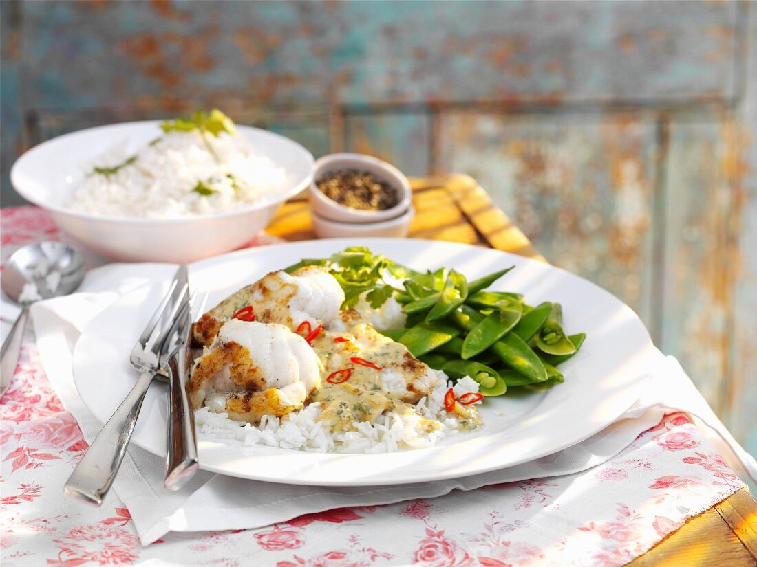 Monkfish with a coconut and chilli sauce on a bed of rice with mange tout