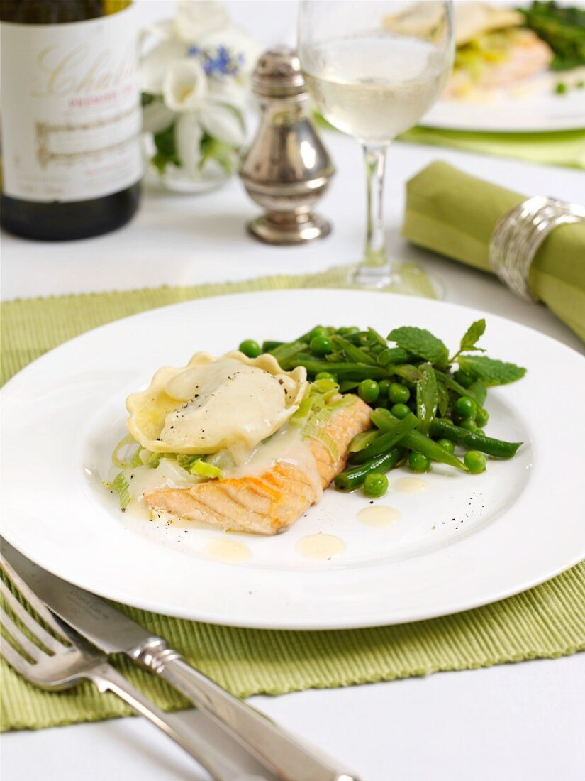 A salmon fillets with ravioli and vegetables