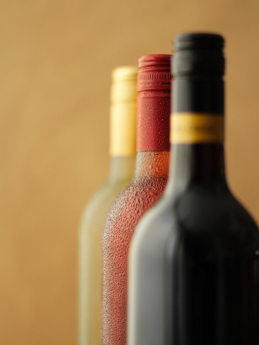 Three bottles of wine: red wine, rose wine and white wine