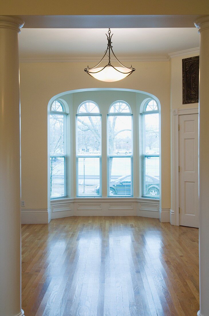 Empty room in apartment with hardwood floor and bay window