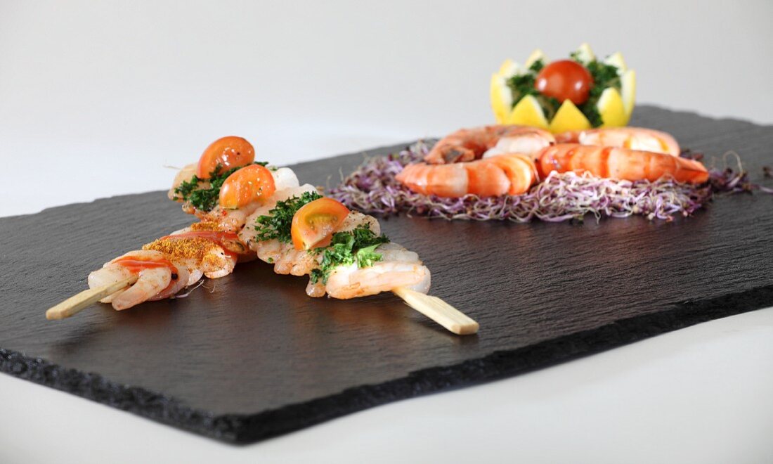Prawn kebabs and King prawns on a slate plater