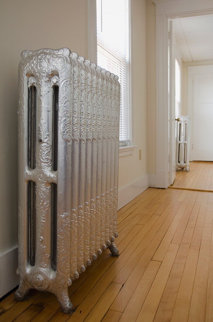 Empty room in apartment with hardwood floor and heater