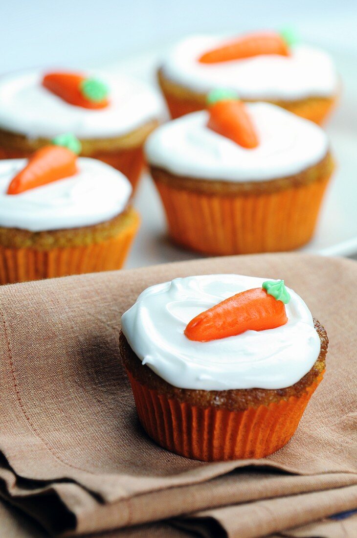 Carrot cupcakes topped with cream cheese