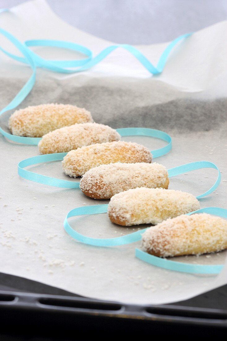 Coconut and lime biscuits on a piece of paper with a ribbon