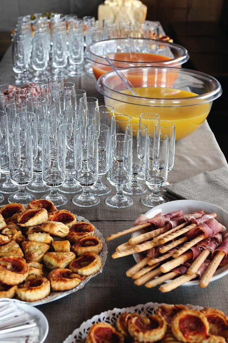 Mini pizzas, grissini and punch on a buffet table (Italy)