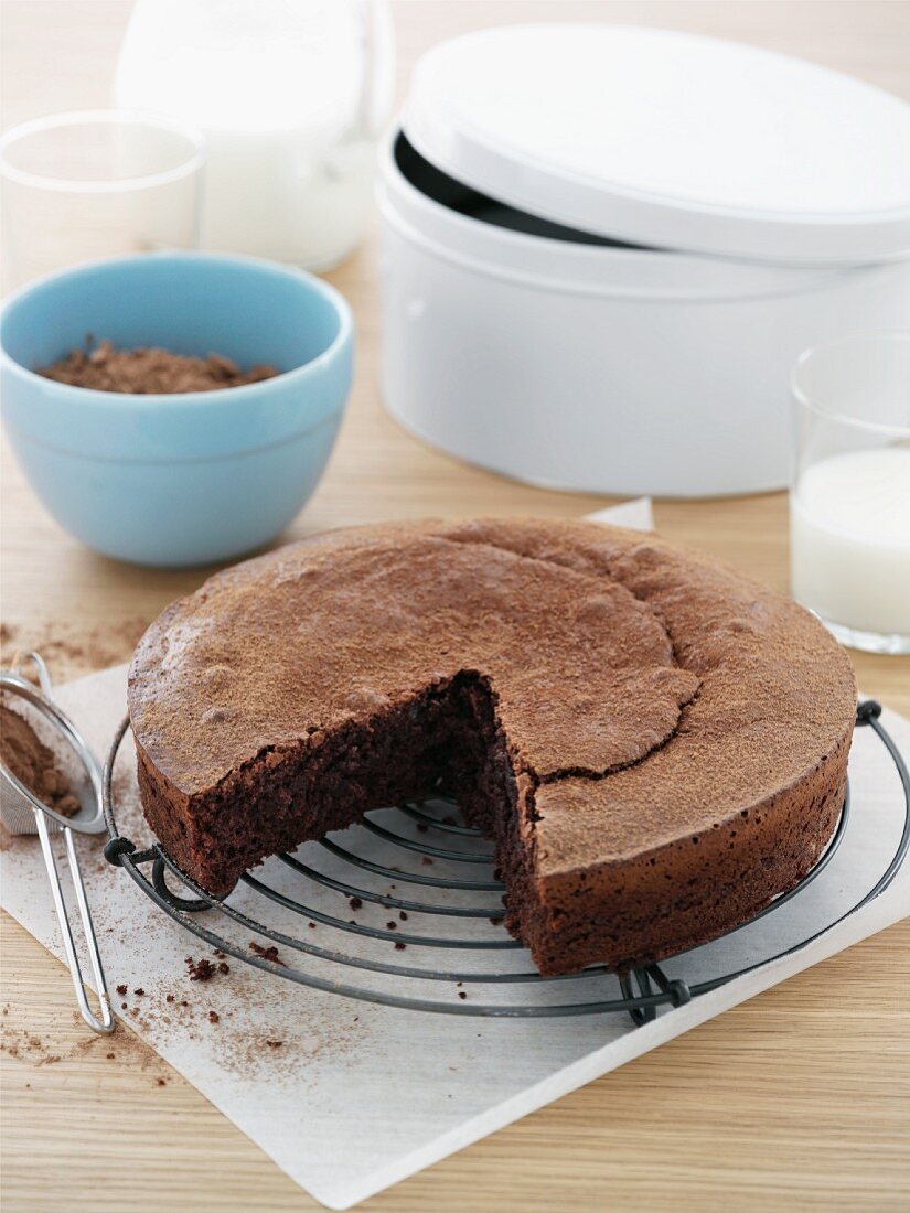 A flourless chocolate cake on a wire rack