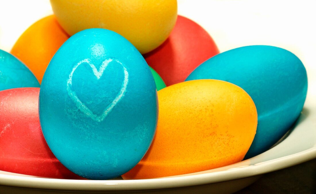 Colourful Easter eggs, one decorated with a heart