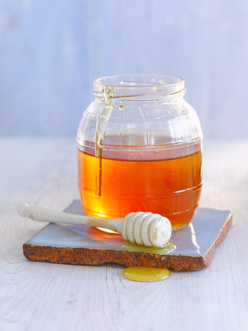 Jar of honey with honey dipper