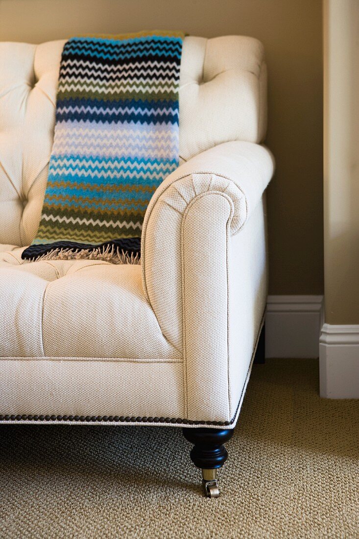 Striped blanket on love seat