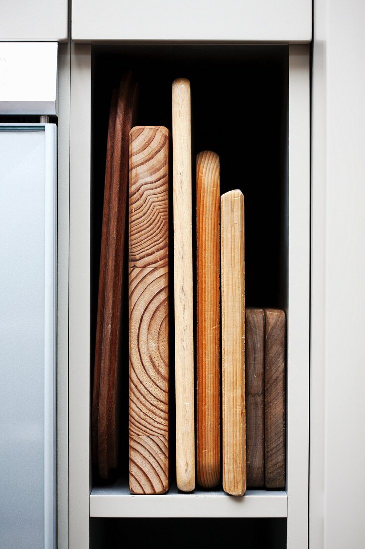 Chopping boards on a kitchen shelf