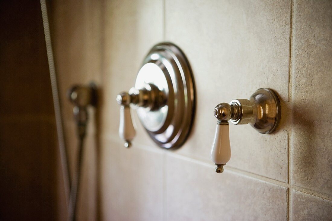 Vintage shower fittings on tiled wall