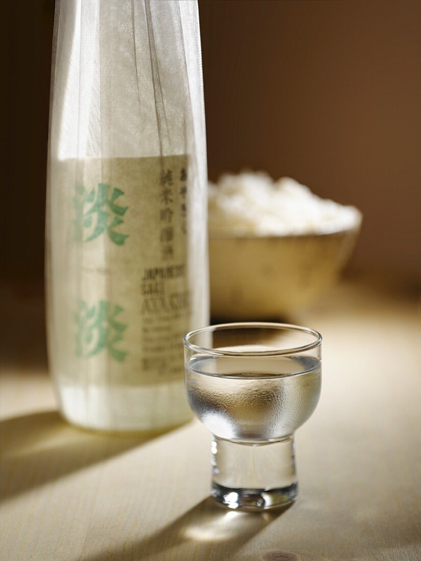 Glass of Sake with Sake Bottle and a Bowl of Rice