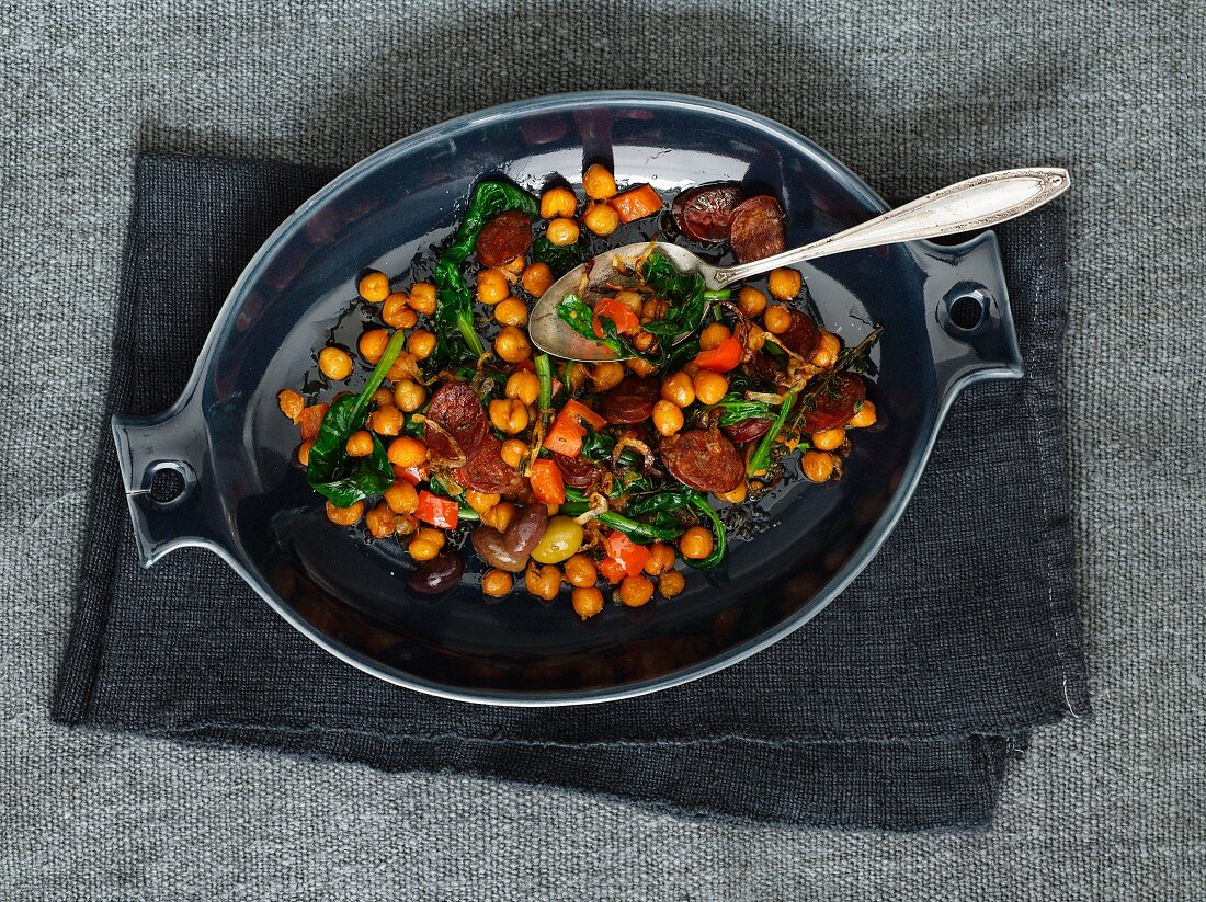 Sliced Sausage with Olives and Mixed Vegetables in a Skillet