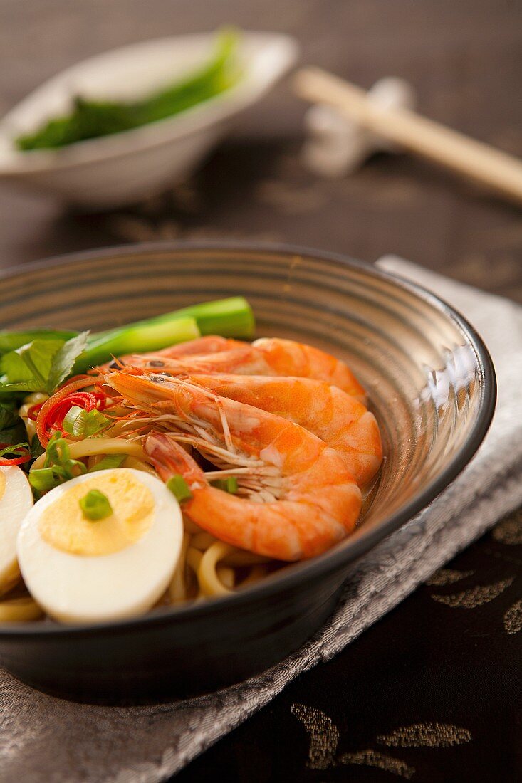 Garnelen mit gekochtem Ei und Gemüse auf asiatische Nudeln