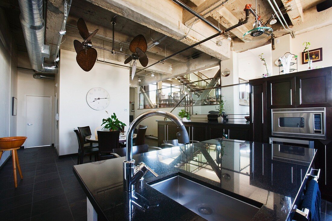 An island counter in a kitchen with a sink