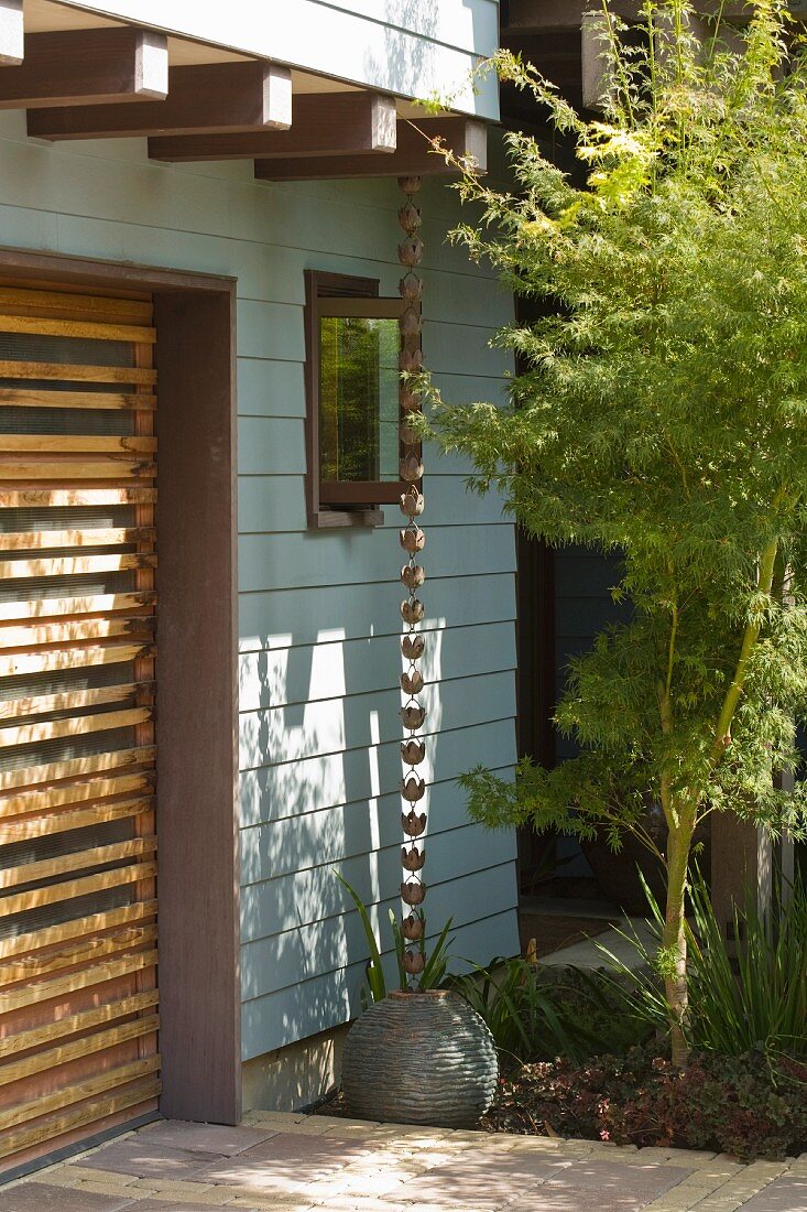 Wooden garage door and blue sided home