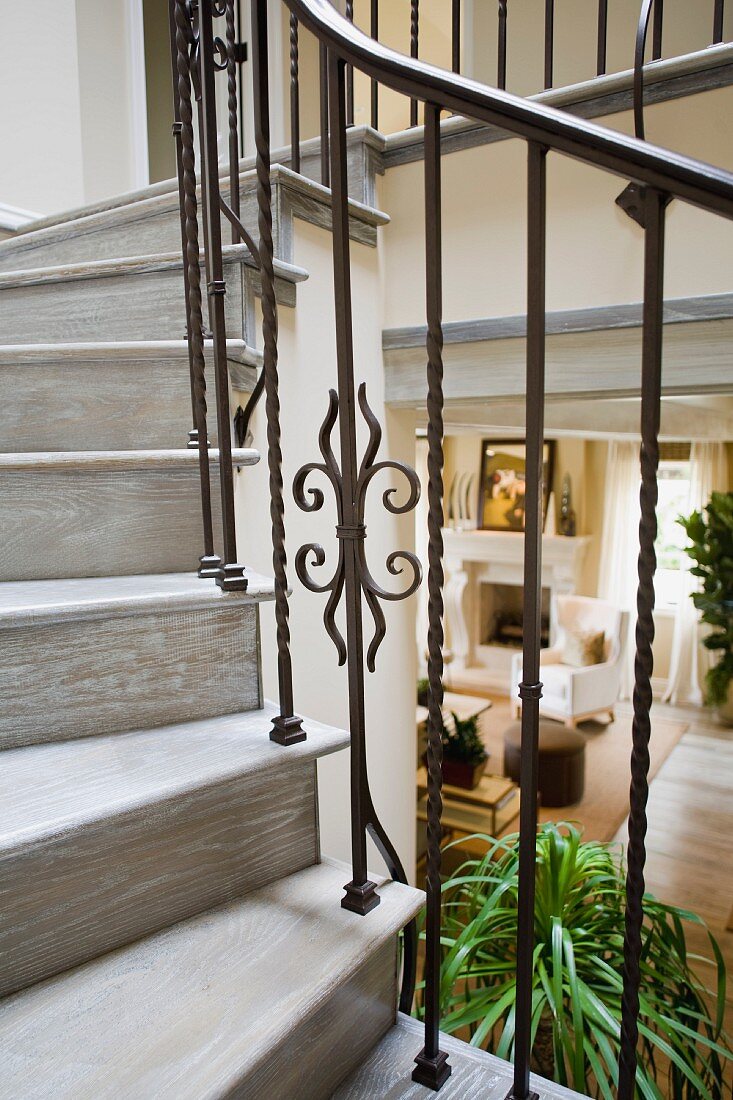 Detail wooden staircase with wrought iron railing