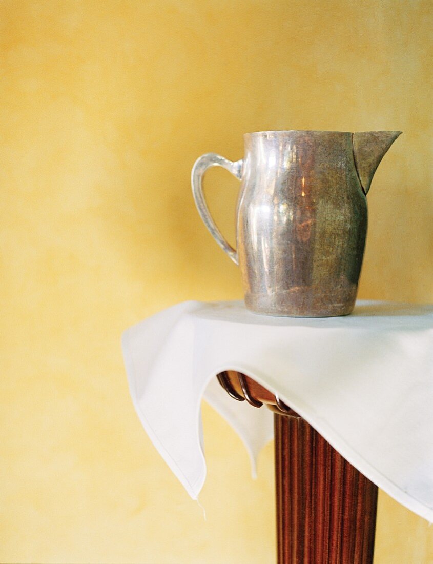 A Metal Water Pitcher on a Table