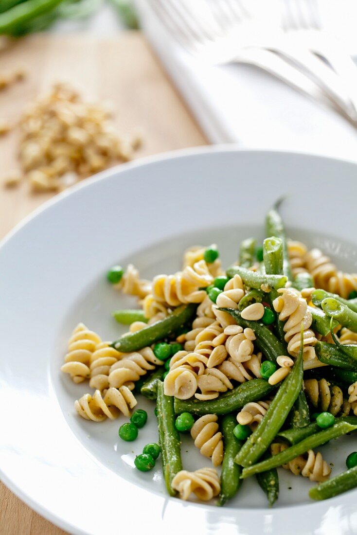 Pasta with Green Beans, Peas and Pine Nuts; In a White Bowl