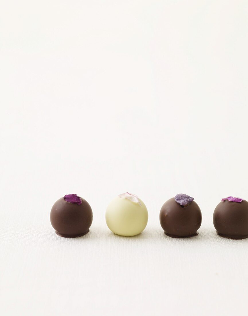 Four Assorted Chocolate Truffles with Candied Flower Petal Garnishes