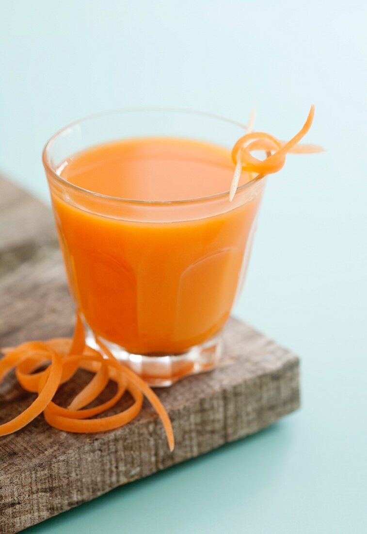 A glass of carrot and orange juice with ginger