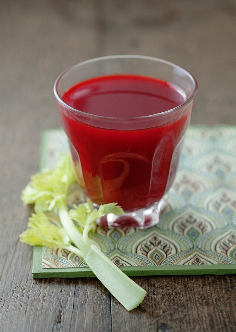 A glass of carrot and beetroot juice with celery