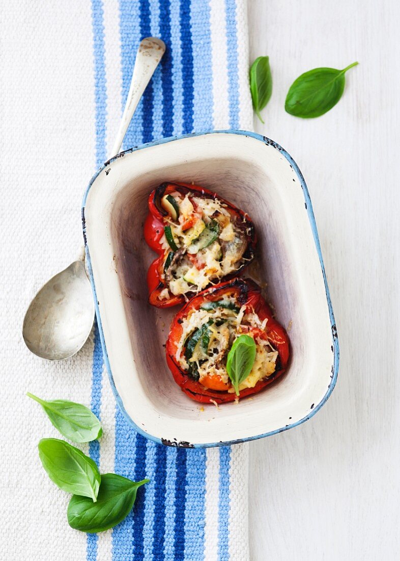 Stuffed peppers filled with courgette, tomatoes and mushrooms