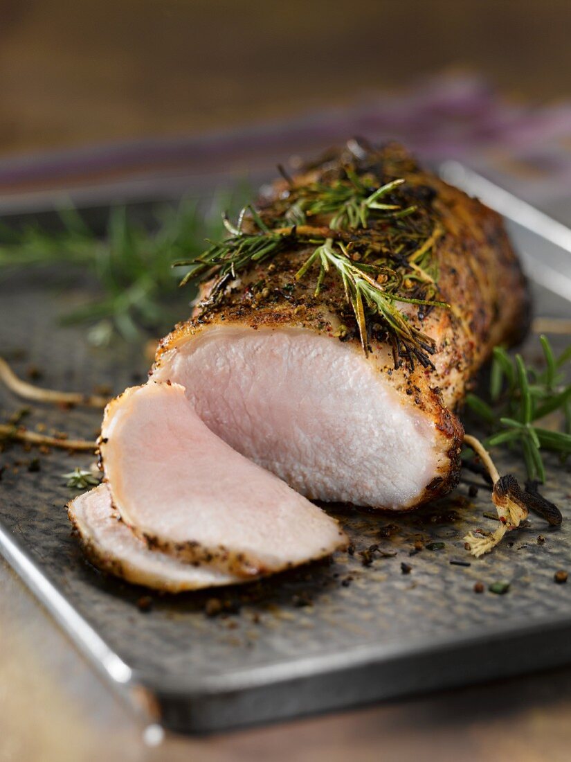 Rosemary Pork Roast Partially Sliced on a Pan