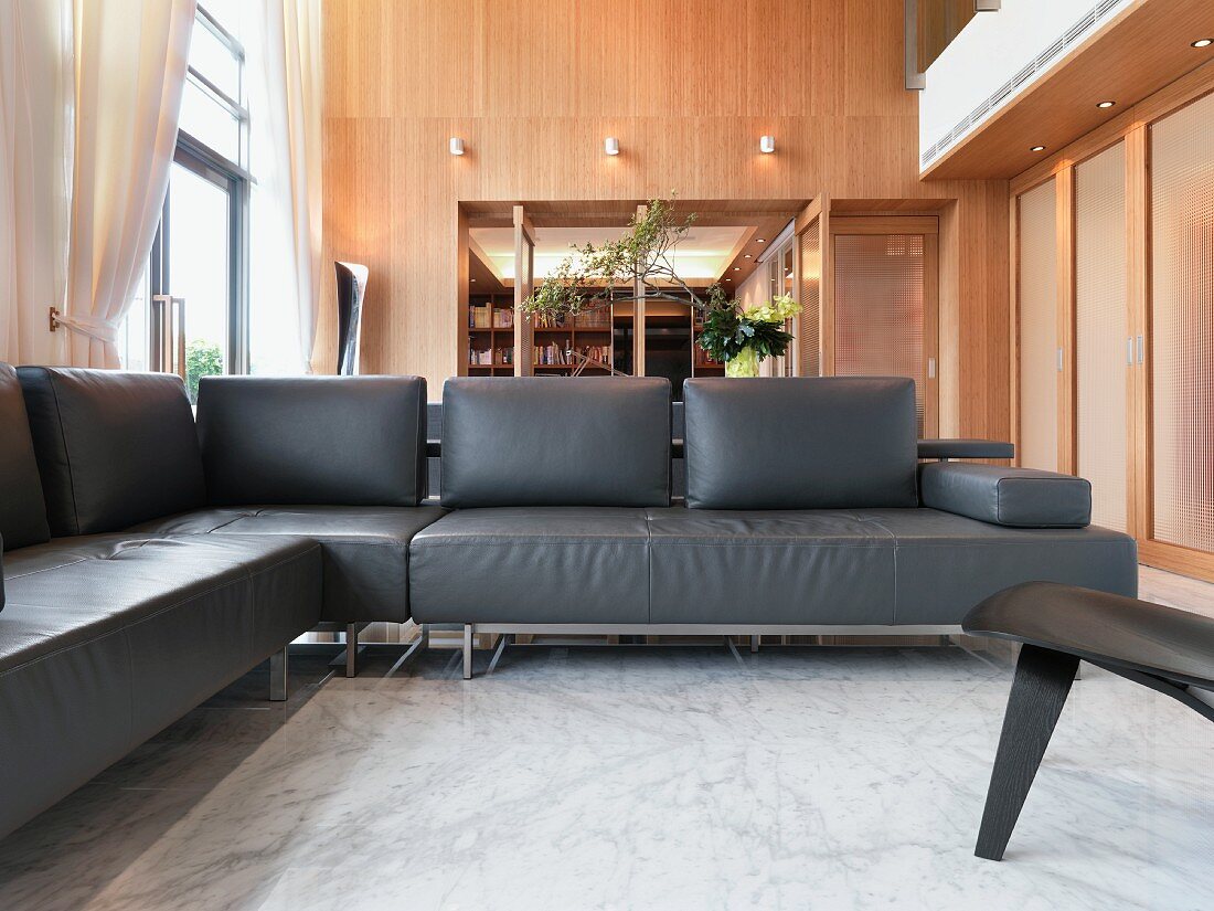 Modern living room with black leather sofa