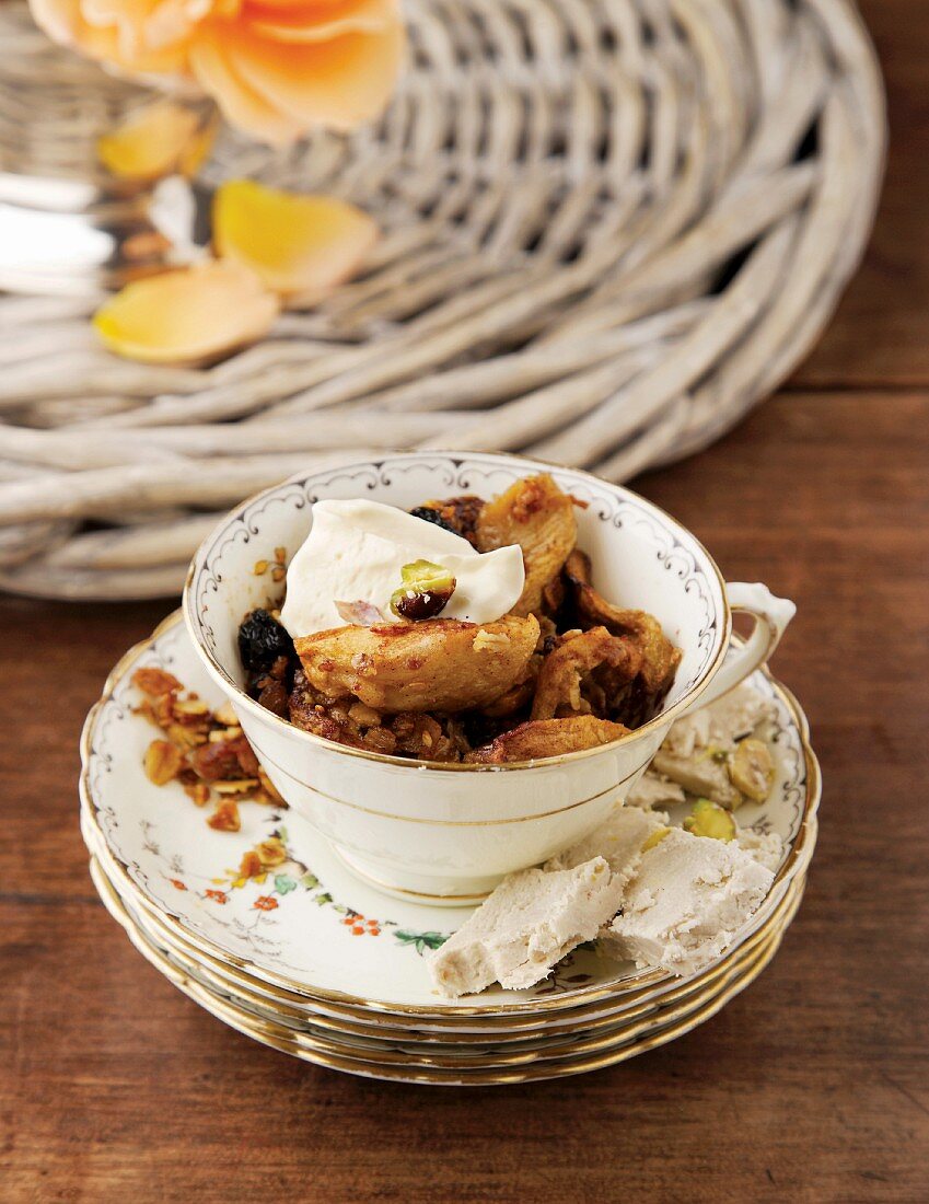 An apple dessert with granola in a teacup