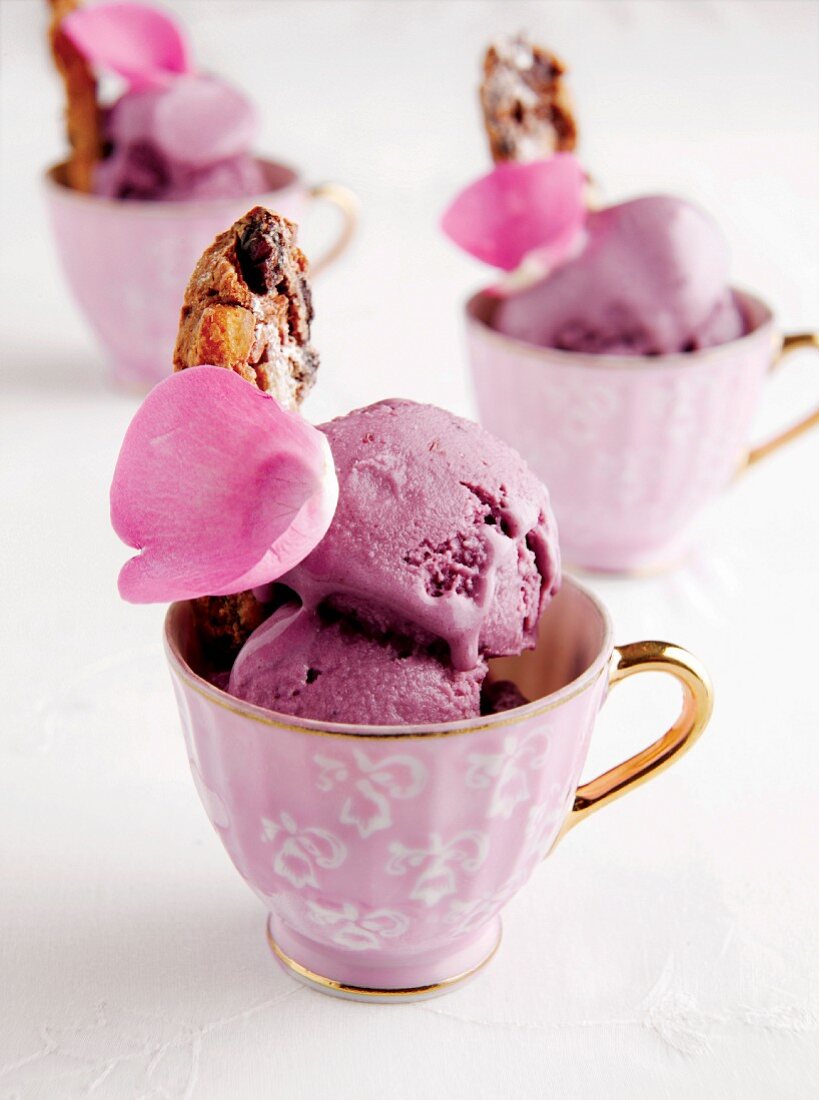 Teacups of berry ice cream with biscotti