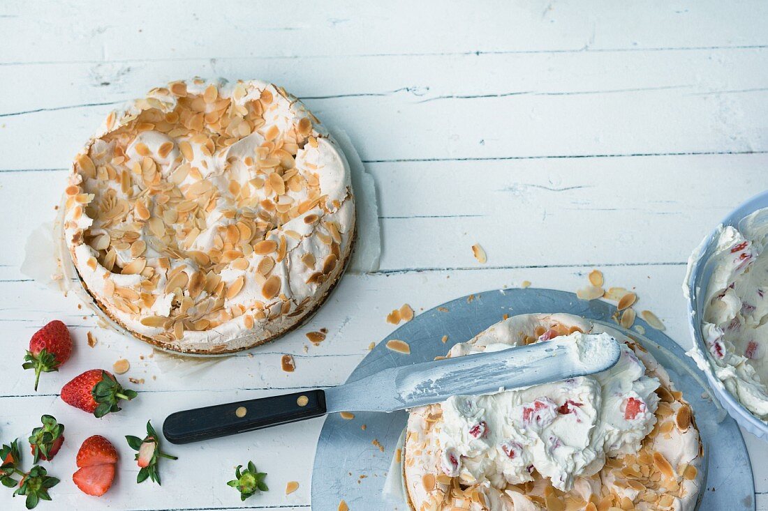 A layer cake with meringue and strawberries