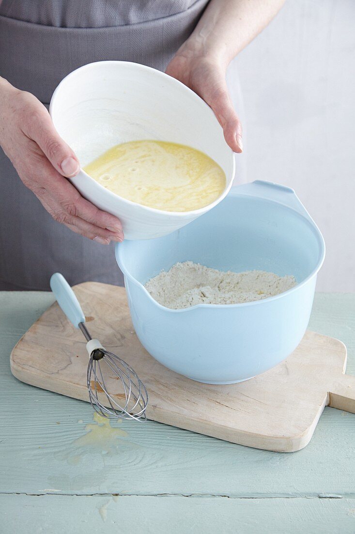 A yeast mixture being added to dry ingredients