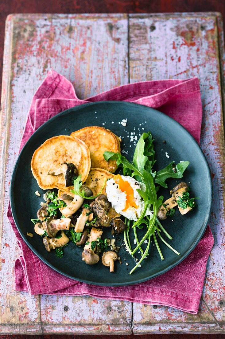 Fried wild mushrooms with quark cakes and poached egg