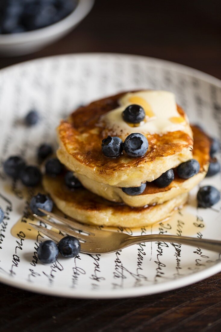 Banana pancakes with blueberries and maple syrup