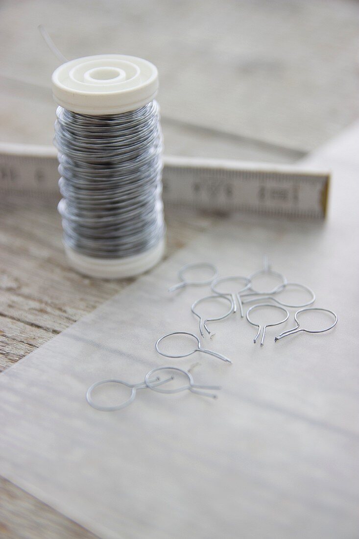 Reel of wire next to hand-made eyelets