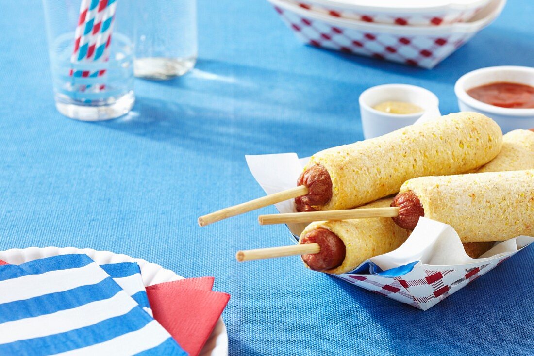 Corn dogs with ketchup and mustard
