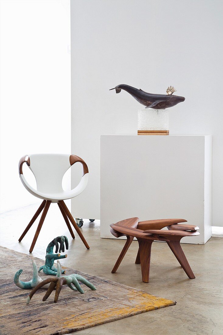 Designer armchair, walnut stool and stylised animal sculptures