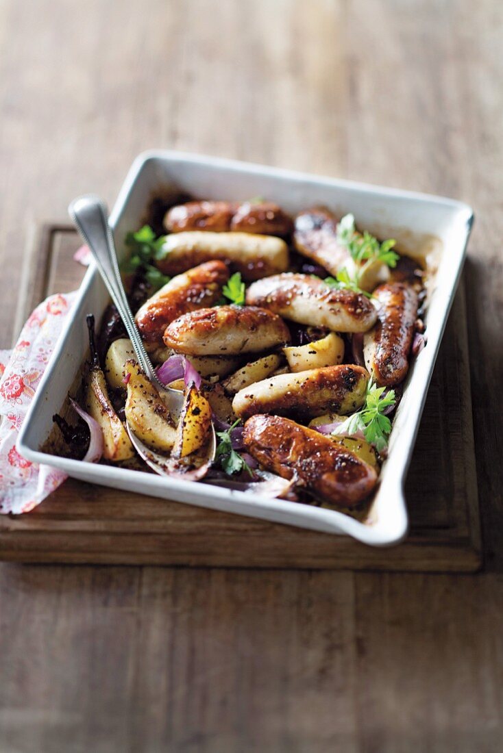 Sausages baked with mustard and pears