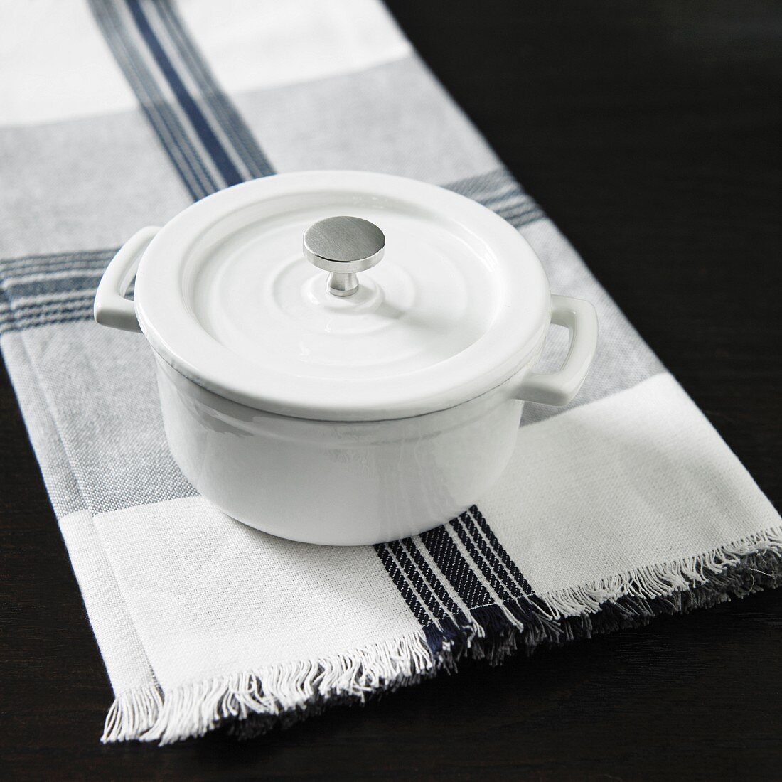 A white pot on a napkin