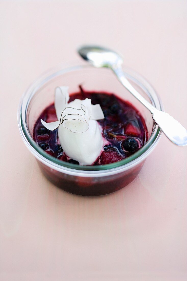 Baked berries in a glass with jasmine flowers and coconut sorbet