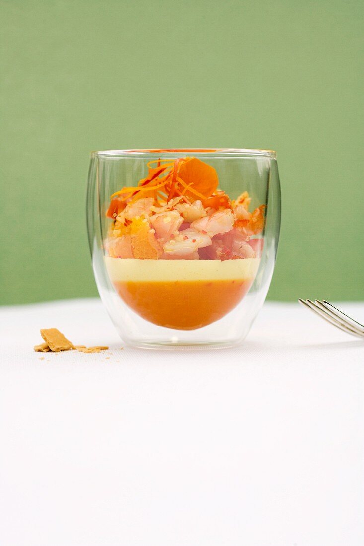 Shrimp and citrus salad with sour cream mousse and orange and chilli jelly in a glass