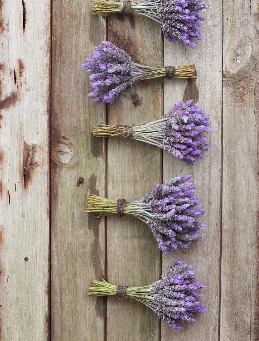 Several bunches of lavender on a wooden surface