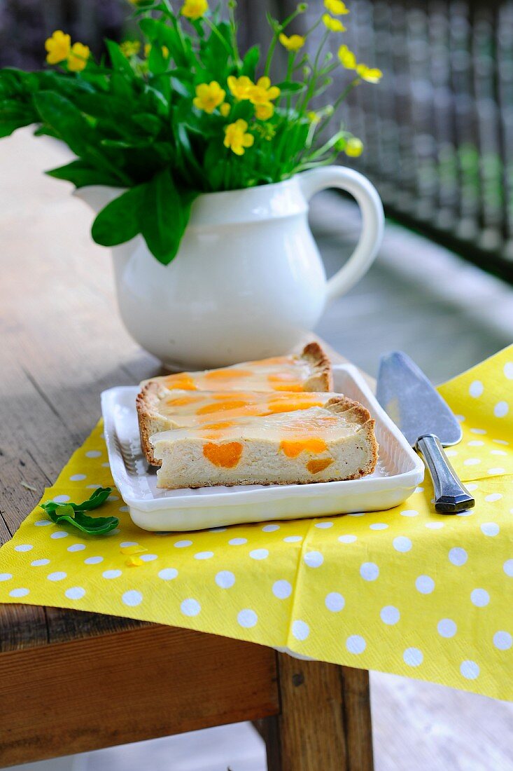 Sour cream cake with apricots on a balcony table