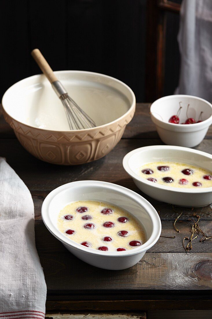 Unbaked cherry clafoutis in baking dishes