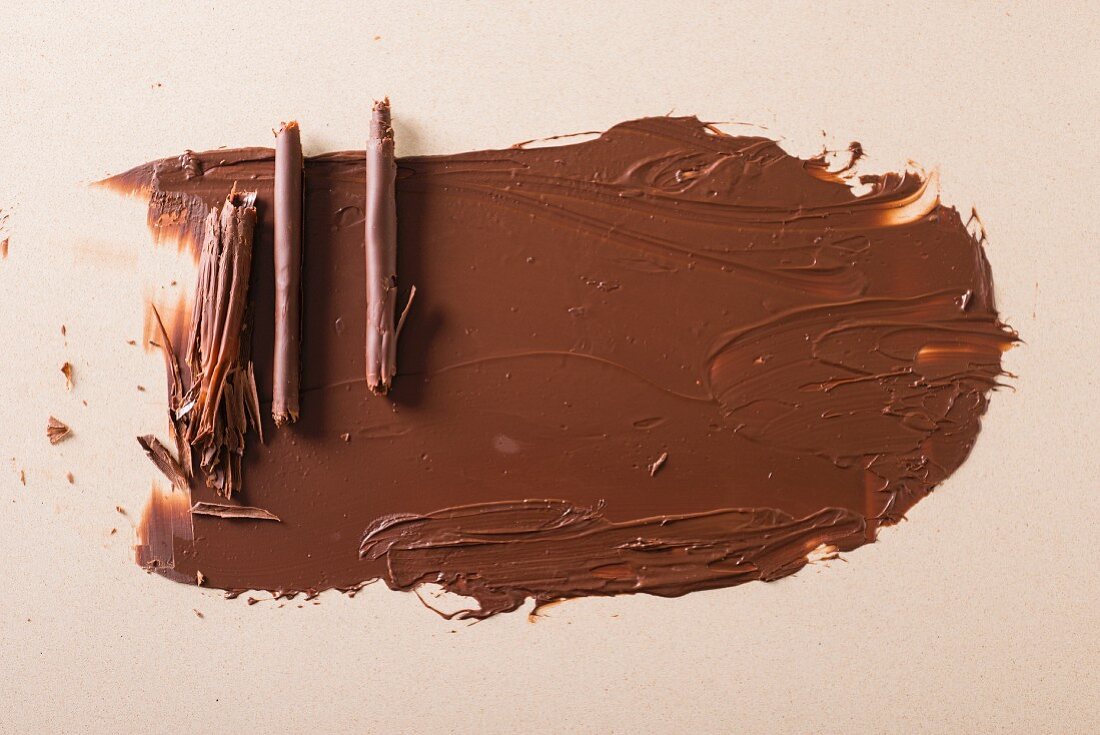 Chocolate rolls and grated chocolate as cake decoration