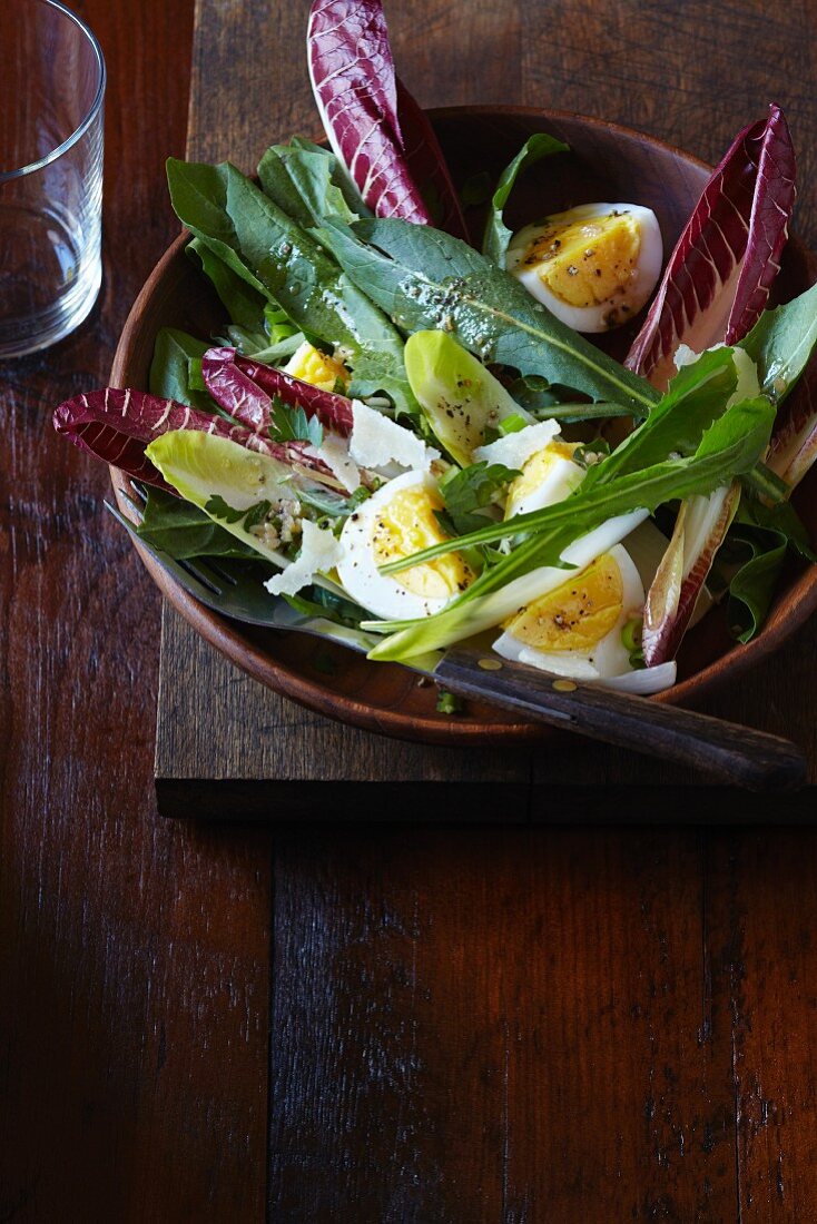A green salad with egg and Parmesan