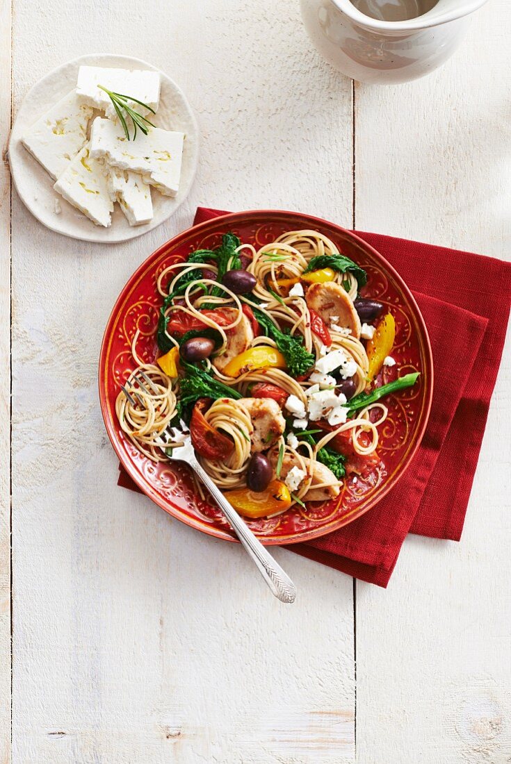 Greek-style spaghetti with chicken, feta cheese, olives, rapini and peppers