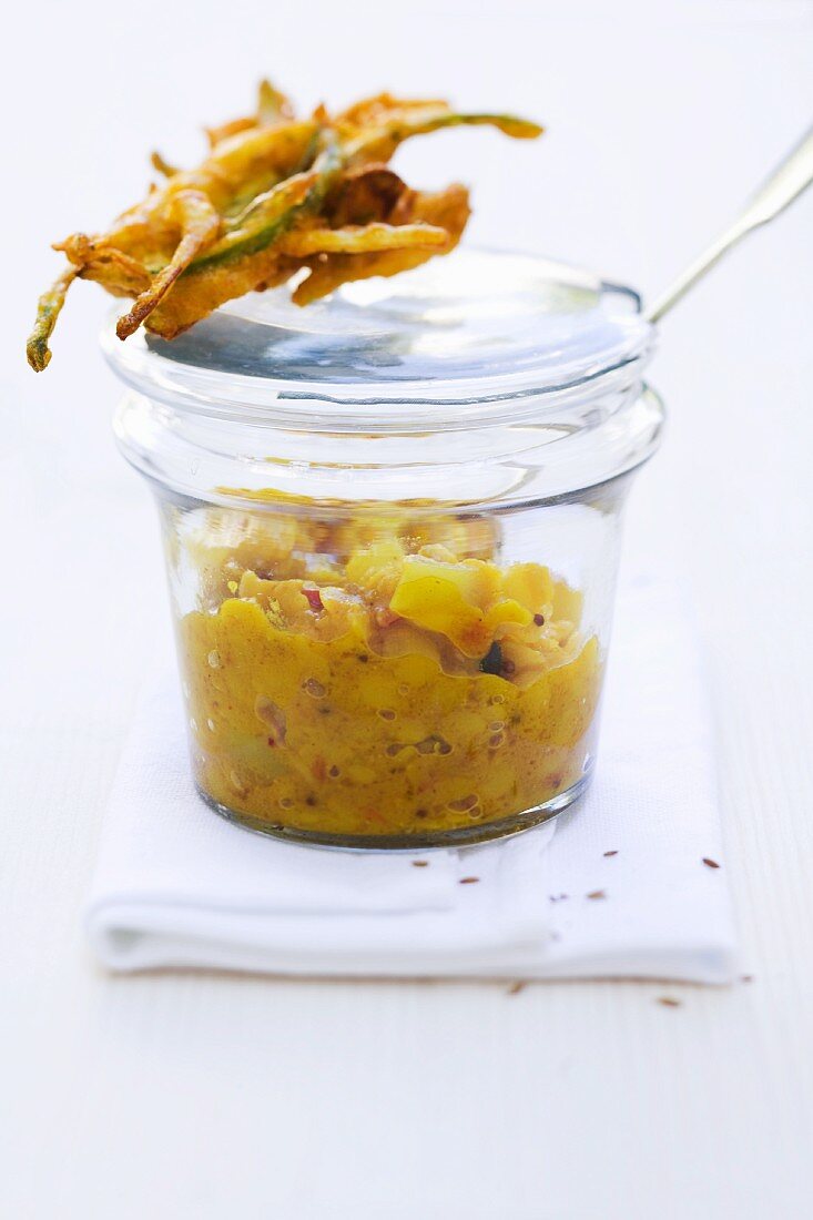 Yellow lentil darling with asparagus and lime leaf pakoras in a jar