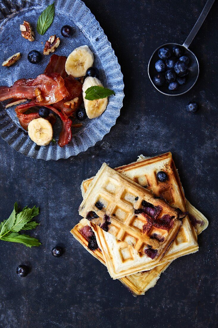 Blueberry waffles with bananas and bacon